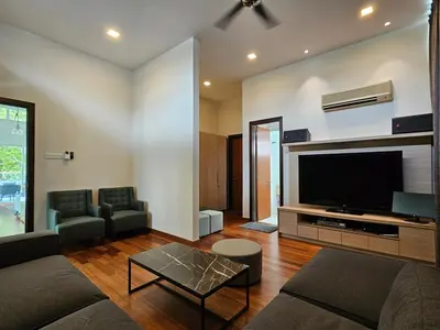 a living room with a couch and a tv at Villa Homescape, Mont Kiara in Kuala Lumpur