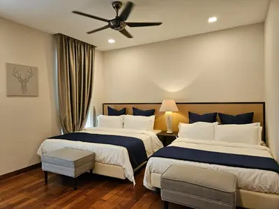 a bedroom with two beds and a ceiling fan at Villa Homescape, Mont Kiara in Kuala Lumpur