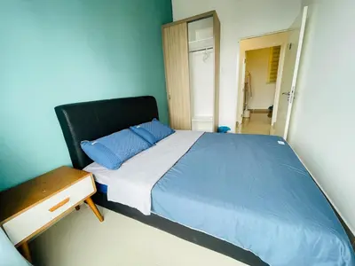 a bedroom with a large bed with blue sheets and a mirror at Lavile Homestay in Kuala Lumpur