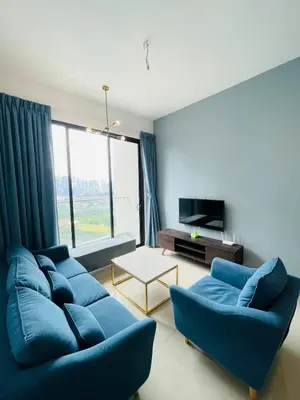 a living room with two blue couches and a tv at Lavile Homestay in Kuala Lumpur