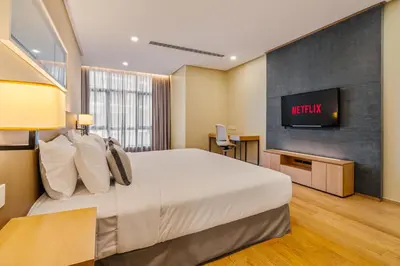 a hotel room with a bed and a television at 188 Suites KLCC by Soulasia in Kuala Lumpur