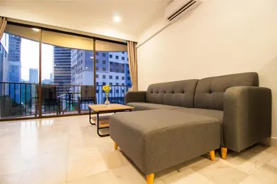 a living room with a couch and a table at Downtown Condo KL City - 18 pax in Kuala Lumpur
