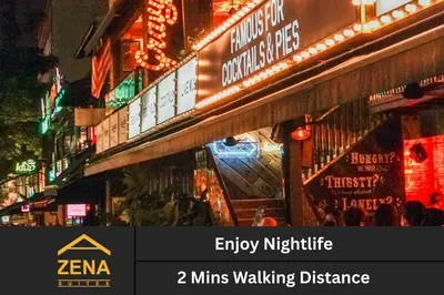 a sign for a store in a city at night at Downtown Condo KL City - 18 pax in Kuala Lumpur