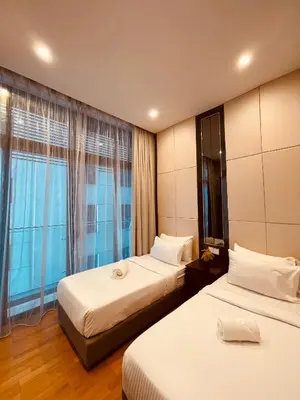 a hotel room with two beds and a window at Dorsett Suites Kuala Lumpur By AFA in Kuala Lumpur