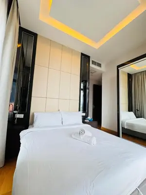 a large white bed in a room with two beds at Dorsett Suites Kuala Lumpur By AFA in Kuala Lumpur