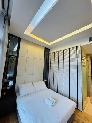 a bedroom with a bed with two towels on it at Dorsett Suites Kuala Lumpur By AFA in Kuala Lumpur