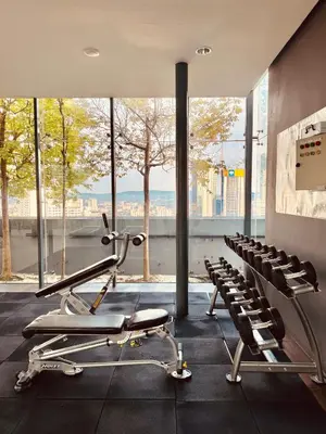 a gym with cardio equipment and a large window at Dorsett Suites Kuala Lumpur By AFA in Kuala Lumpur