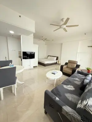 a living room with a couch and a table at Times Residence At BTS Kuala Lumpur in Kuala Lumpur