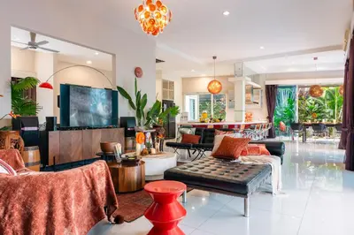 a living room filled with furniture and a flat screen tv at Flame of the Forest Retreat 38Pax 8R7B Pool Villa Kuala Lumpur in Kuala Lumpur