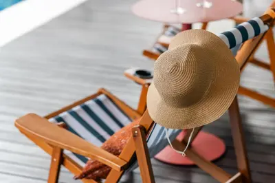 a straw hat sitting on a rocking chair at Flame of the Forest Retreat 38Pax 8R7B Pool Villa Kuala Lumpur in Kuala Lumpur