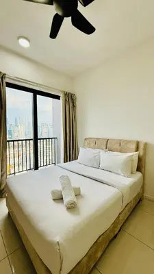 a bedroom with a large bed with a ceiling fan at Chambers Serviced Suites Kuala Lumpur in Kuala Lumpur