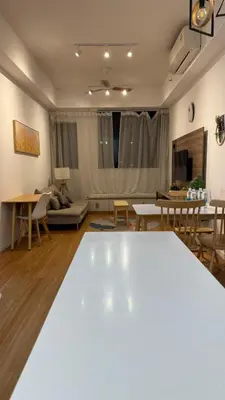 a living room with a white table and chairs at Chambers Serviced Suites Kuala Lumpur in Kuala Lumpur