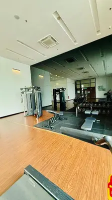 an empty gym with a wooden floor and machines in a room at Chambers Serviced Suites Kuala Lumpur in Kuala Lumpur