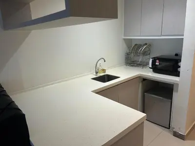 a small kitchen with a sink and a microwave at Times Square by Perfect in Kuala Lumpur