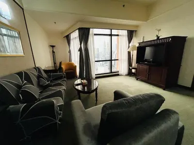 a living room with a couch and a tv at Times Square by Perfect in Kuala Lumpur