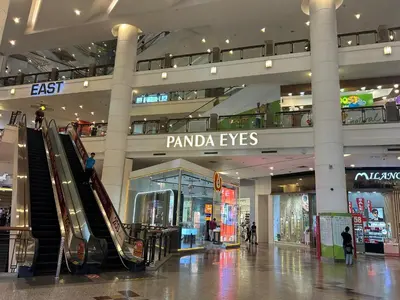 a shopping mall with an escalator in the middle at Times Square by Perfect in Kuala Lumpur