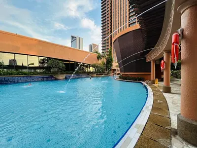 a swimming pool with a fountain in a building at Times Square by Perfect in Kuala Lumpur