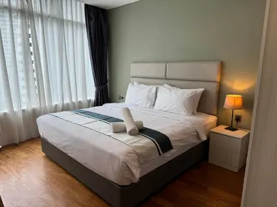 a bedroom with a bed with a towel on it at Vortex Suites klcc City Malaysia in Kuala Lumpur