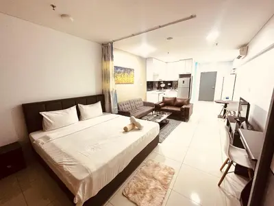 a bedroom with a bed and a living room at Summer Hotel and Condo Suites Nearby KLCC Area in Kuala Lumpur