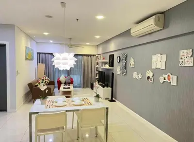 a living room with a table and chairs in a room at Summer Hotel and Condo Suites Nearby KLCC Area in Kuala Lumpur