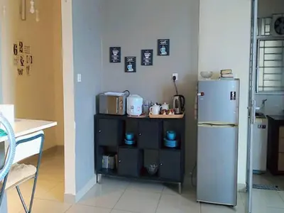 a kitchen with a refrigerator and a shelf with appliances at PV21 Luxe Comfort 3 Bedroom Modern Homestay in Prime Location near Setapak Central Mall in Kuala Lumpur