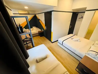 a room with two beds and a mirror at Seeds Hotel Bukit Bintang in Kuala Lumpur