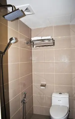 a bathroom with a toilet and a shower at Xpeed Holiday Hotel in Kuala Lumpur