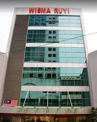 a building with a sign on the side of it at Xpeed Holiday Hotel in Kuala Lumpur