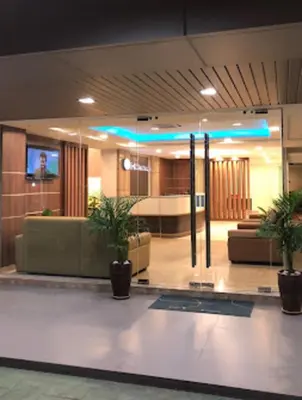 a lobby with couches and potted plants in a building at Xpeed Holiday Hotel in Kuala Lumpur