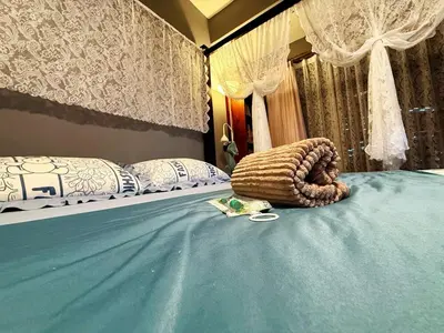 a bedroom with two beds with a blue bedspread at Bintang Nyonya Villa-A self designed Home in Kuala Lumpur