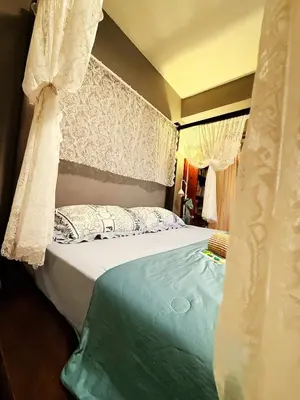 a bedroom with a bed with a canopy and curtains at Bintang Nyonya Villa-A self designed Home in Kuala Lumpur