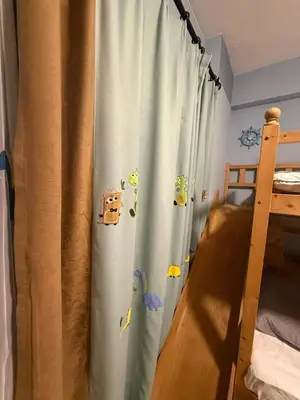 a bedroom with a curtain with animals on it at Bintang Nyonya Villa-A self designed Home in Kuala Lumpur