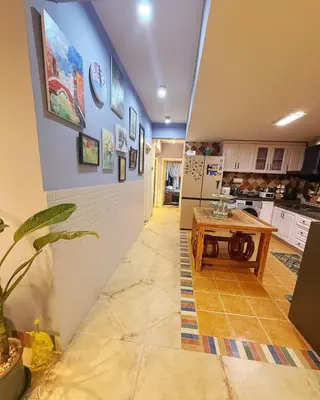 a kitchen with a table in the middle of a room at Bintang Nyonya Villa-A self designed Home in Kuala Lumpur