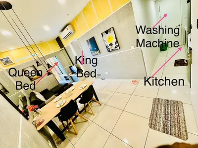 a dining room with a table and chairs in a room at Robertson Residence Main City Kuala Lumpur in Kuala Lumpur