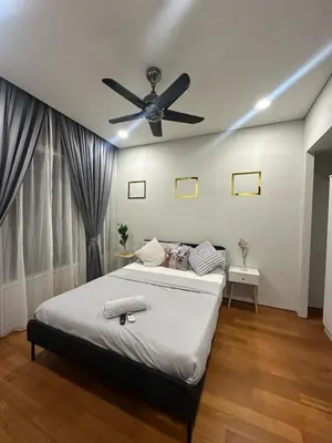a bedroom with a bed with a ceiling fan at Modern Condo Next To Petronas Towers in Kuala Lumpur