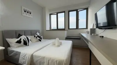 a bedroom with a large bed with a tv on it at Nest Heaven Host in Kuala Lumpur