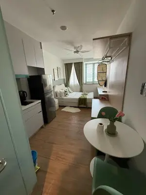 a small kitchen and living room with a table at Nest Heaven Host in Kuala Lumpur