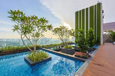 a swimming pool with trees on top of a building at Riveria City KL Sentral by Nest Suite in Kuala Lumpur