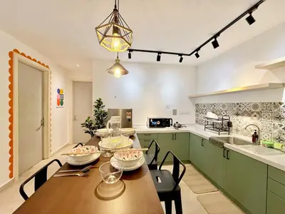 a kitchen with a wooden table with bowls of food on it at VibeHaus 11px 2R2B Pavillion Bukit Bintang 1mins in Kuala Lumpur