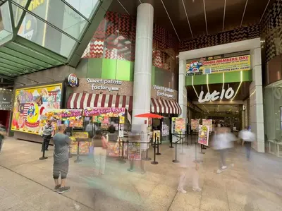 a group of people walking around a shopping mall at VibeHaus 11px 2R2B Pavillion Bukit Bintang 1mins in Kuala Lumpur