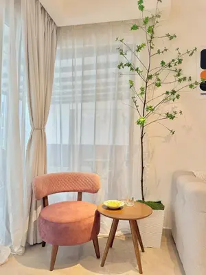 a living room with a chair and a table at VibeHaus 11px 2R2B Pavillion Bukit Bintang 1mins in Kuala Lumpur
