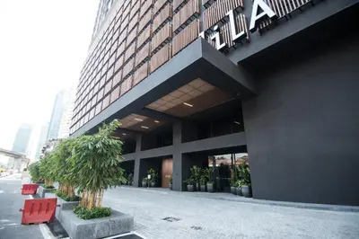 a building with red chairs in front of it at Bangsar LRT Suites EST by LSA in Kuala Lumpur