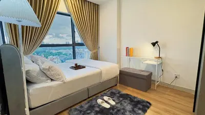 a bedroom with a bed with a large window at The Thant Suite in Kuala Lumpur