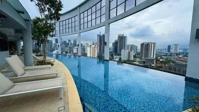 a swimming pool on top of a building with a city at The Thant Suite in Kuala Lumpur