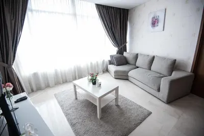 a living room with a couch and a table at Vortex KLCC by LSA in Kuala Lumpur