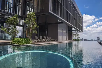 a building with a swimming pool in front of a building at Happy holiday at Lucentia Residence in Kuala Lumpur
