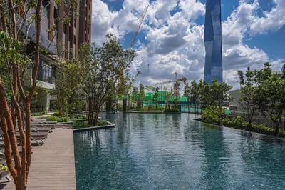 a swimming pool with a tower in the background at Happy holiday at Lucentia Residence in Kuala Lumpur