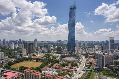 a view of a city with a tall skyscraper at Happy holiday at Lucentia Residence in Kuala Lumpur