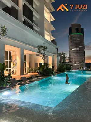 a man in a swimming pool in a building at Klcc Quill Cozy& Chill Suite 3-5Pax HD1080 Netflix in Kuala Lumpur