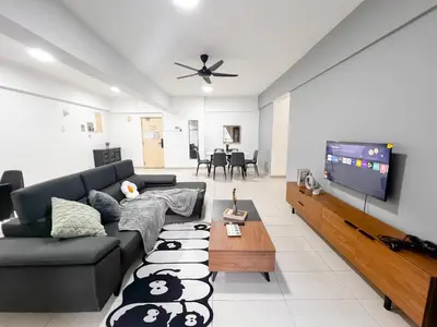 a living room with a couch and a flat screen tv at Fahrenheit 88 Bukit Bintang by Manhattan Group in Kuala Lumpur